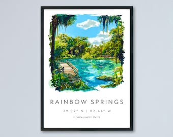 May include: A framed watercolour print of Rainbow Springs, Florida. The artwork shows a vibrant turquoise spring with a wooden boardwalk, surrounded by lush green trees and foliage. The text "Rainbow Springs" and coordinates are displayed.