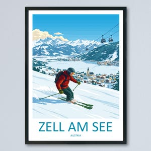 Op de afbeelding: Een ingelijste reisprent voor Zell am See, Oostenrijk, met een skiër die een besneeuwde helling afdaalt. De prent toont een bergketen, een meer en een stad. De tekst "Zell am See" en "Austria" staan onderaan.