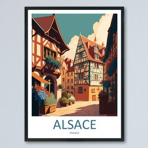 May include: A vintage travel poster featuring a colorful illustration of a street in Alsace, France. The poster has the text "ALSACE" in blue and "FRANCE" in smaller text below.