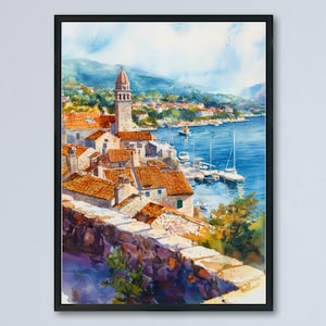 May include: Watercolor painting of a coastal town with red-tiled roofs, a tall bell tower, and a harbor filled with boats. The artwork captures the vibrant colors of the buildings, the blue sea, and the sky, framed in a black border.