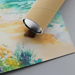 May include: A rolled-up art print featuring a watercolor painting of a beach scene. The artwork depicts a sandy shore, ocean waves, and colorful vegetation. The print is partially obscured by a brown cardboard tube with silver end caps.