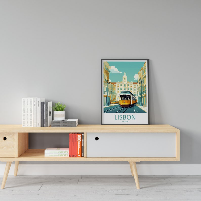 May include: A wooden media console with a white drawer and open shelves. The console has a black framed poster with a colorful illustration of a tram in Lisbon, Portugal. The poster reads "LISBON, Portugal".