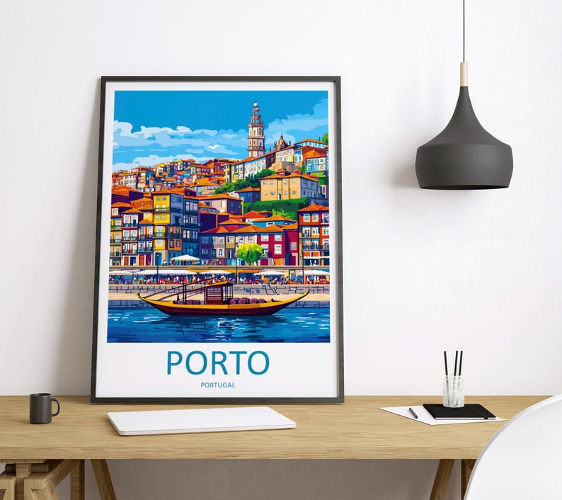 May include: A framed art print of Porto, Portugal, featuring a colorful cityscape with buildings and a river. A traditional boat floats on the water. The word "PORTO" is printed in teal below the image, with "PORTUGAL" underneath.