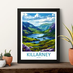 May include: A framed poster with a colorful illustration of a lake and mountains. The text "KILLARNEY, IRELAND" is at the bottom of the poster.