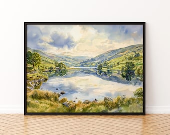 May include: Watercolor landscape painting of a lake surrounded by green hills and trees under a cloudy sky. The artwork is framed in a black frame and is displayed on a wooden floor.
