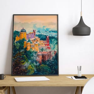 May include: A framed watercolor print of a colorful castle atop a lush, green hillside. The castle features a yellow dome, purple walls, and red towers. The artwork is set against a backdrop of blue and orange hues.
