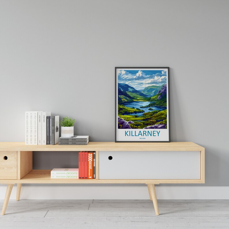May include: A framed poster with a scenic view of Killarney, Ireland. The poster features a lake surrounded by lush green hills and a blue sky with white clouds. The text "KILLARNEY, IRELAND" is printed below the image.