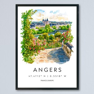 May include: A framed watercolour print of Angers, France, depicting a scenic view of the city with a river, bridge, and buildings. The print includes the city's name, coordinates, and the country. The artwork is surrounded by lush greenery and flowers.