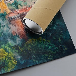 May include: Watercolor print of a European castle and lush green forest. The artwork features a detailed depiction of the castle with red roofs and white walls. A brown cardboard tube rests on the print, partially obscuring the image.