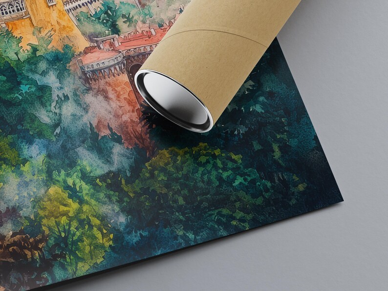 May include: Watercolor print of a European castle and lush green forest. The artwork features a detailed depiction of the castle with red roofs and white walls. A brown cardboard tube rests on the print, partially obscuring the image.