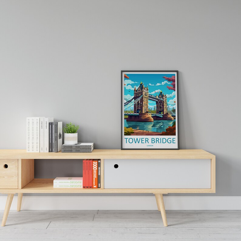 May include: A framed illustration of Tower Bridge in London, England. The bridge is depicted in a colorful, stylized design with a blue sky and water. The frame is black and the text "Tower Bridge London" is printed below the image.