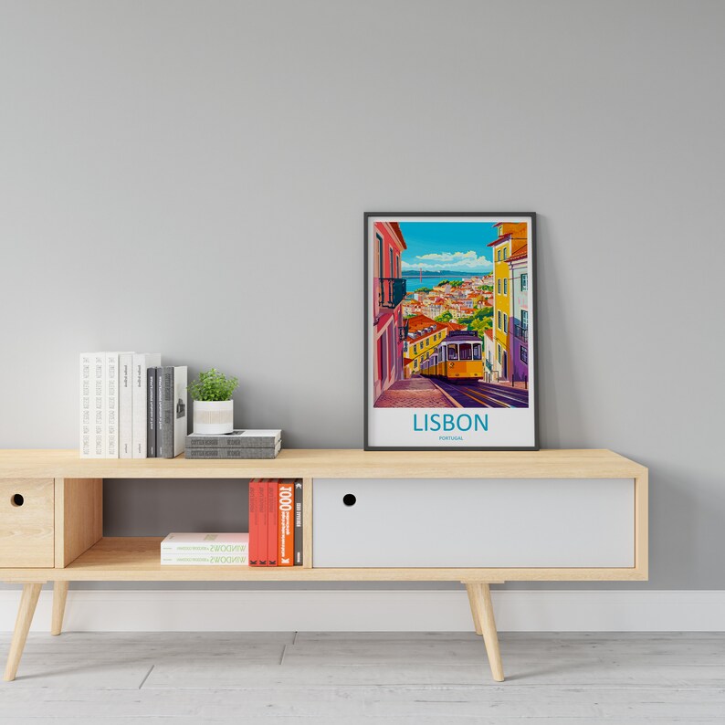 May include: A wooden media console with a white drawer and open shelves. A framed poster of a colorful cityscape with a yellow tram on a hill is displayed above the console. The poster reads "LISBON, PORTUGAL".