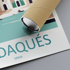 May include: A poster with a colorful illustration of a town with boats on a body of water. The text "Cadaqu&eacute;s, Spain" is printed on the poster.