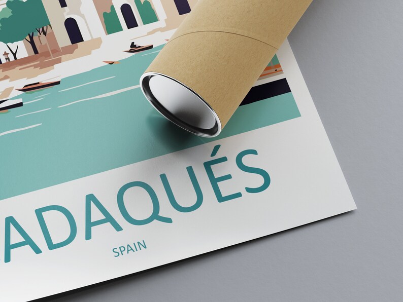 May include: A poster with a colorful illustration of a town with boats on a body of water. The text "Cadaqu&eacute;s, Spain" is printed on the poster.