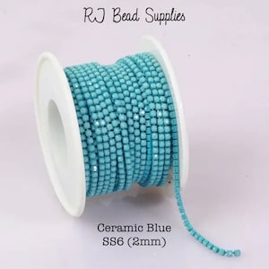 May include: A spool of light blue ceramic bead chain, labelled "Ceramic Blue SS6 (2mm)". The chain is made of small, square beads that are connected together.