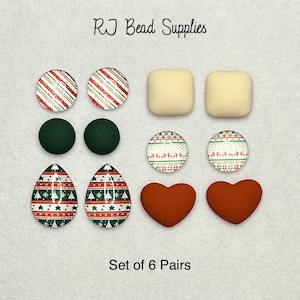 May include: Set of six pairs of Christmas-themed earrings. The earrings are made of glass and metal and feature a variety of designs, including candy canes, snowflakes, and Christmas trees. The earrings are all red, green, and white.