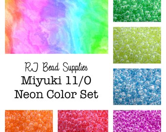 May include: A set of neon colored Miyuki 11/0 seed beads. The beads are arranged in rows of different colors, including green, yellow, blue, orange, red, and purple. The beads are all transparent and have a slight iridescent sheen. The image also includes the text "RJ Bead Supplies Miyuki 11/0 Neon Color Set".