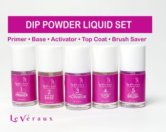 May include: A dip powder liquid set with five bottles labeled Primer, Base, Activator, Top Coat, and Brush. The bottles have white caps and pink labels with the brand name Le Véraux. The text "DIP POWDER LIQUID SET" is at the top.