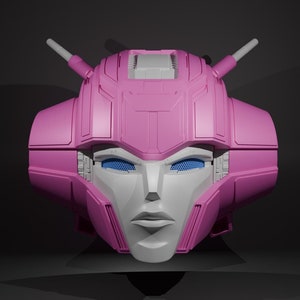 May include: A pink and white robot head with blue eyes. The head has a detailed design with a geometric pattern and a feminine face.