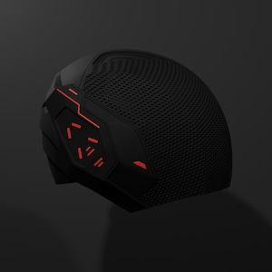 May include: A black helmet with red detailing, featuring a textured, perforated surface. The design includes angular elements and red lines and shapes. The helmet has a futuristic appearance, with a dark background. The overall aesthetic suggests a high-tech or sci-fi theme.
