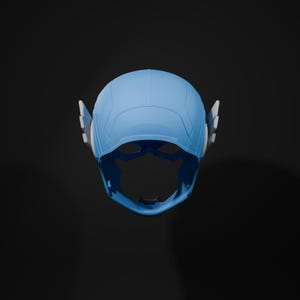May include: A blue and white plastic superhero helmet with a visor. The helmet has a molded design with a pointed top and two side wings.
