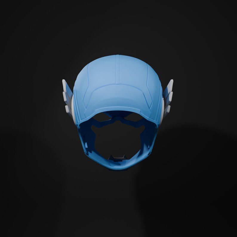 May include: A blue and white plastic superhero helmet with a visor. The helmet has a molded design with a pointed top and two side wings.