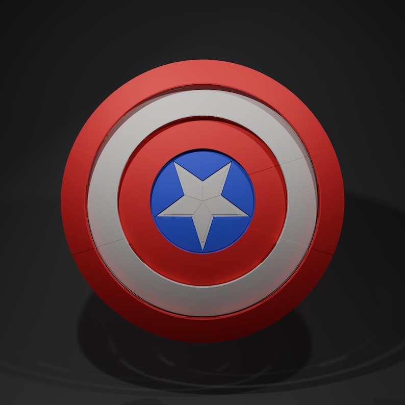May include: A red, white, and blue shield with a star in the center. The shield has a circular design with a red outer ring, a white middle ring, and a blue center with a white star. The shield is a popular item in the superhero genre.