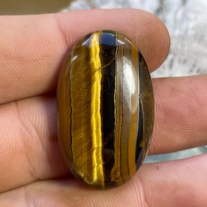 Tigeröga, 51,55 karat. Ädelstenskvalitet. Polerad natursten. Perfekt för samlare eller smyckesdesigners.