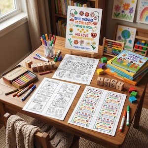 May include: A collection of Christian-themed coloring pages and activity sheets featuring the text Give Thanks To The Lord For He Is Good His Love Endures Forever Psalm 136:1, accompanied by crayons, markers, wooden letter blocks, and a book.