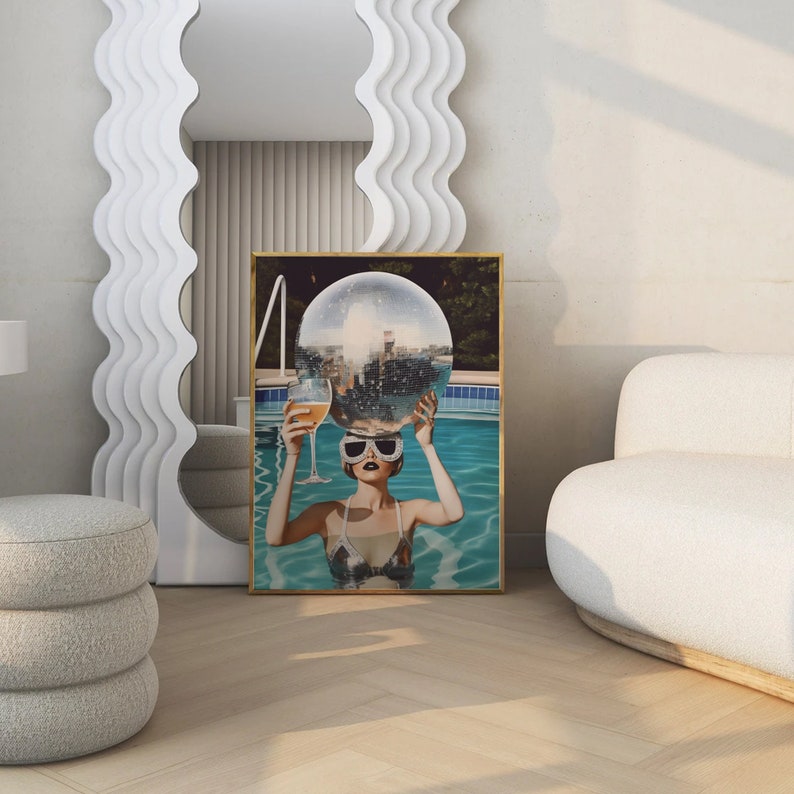 May include: A woman in a pool with a disco ball on her head and a glass of champagne in her hand. The pool is surrounded by greenery and the woman is wearing sunglasses.