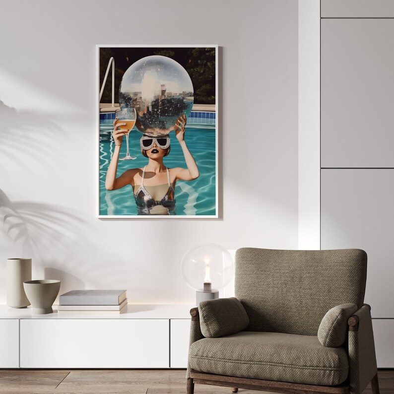 May include: A woman in a swimming pool holding a disco ball over her head and a glass of champagne in her other hand.