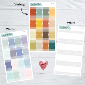 May include: Three sheets of sticker paper with different color palettes. The first sheet is labeled "Vintage" and has a variety of warm colors, including orange, yellow, brown, and green. The second sheet is labeled "Winter" and has a variety of cool colors, including blue, purple, and gray. The third sheet is labeled "White" and has a white background with a grid of blank squares.