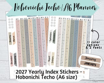 May include: A sheet of 2027 yearly index stickers for a Hobonichi Techo A6 planner. The stickers feature vertical monthly calendars in various muted colours, along with month labels in two different fonts. Text includes Hobonichi Techo/A6 Planner.