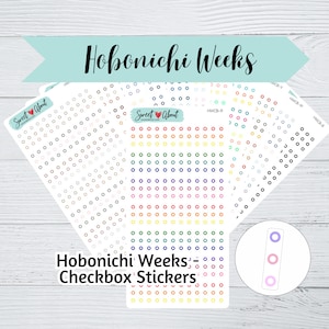 Könnte beinhalten: Ein Satz bunter Aufkleberbögen mit Kreisen zur Verwendung als Kontrollkästchen-Aufkleber für einen Hobonichi Weeks-Planer. Die Aufkleber sind in verschiedenen Farben, darunter Schwarz, Weiß, Grau, Rosa, Orange, Gelb, Grün, Blau und Lila.