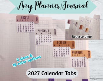 May include: A set of 2027 calendar tabs for planners and journals, featuring monthly grids for August, September, October, and November. The tabs display the month name, days of the week, and numerical dates, with a reverse view showing adhesive application.