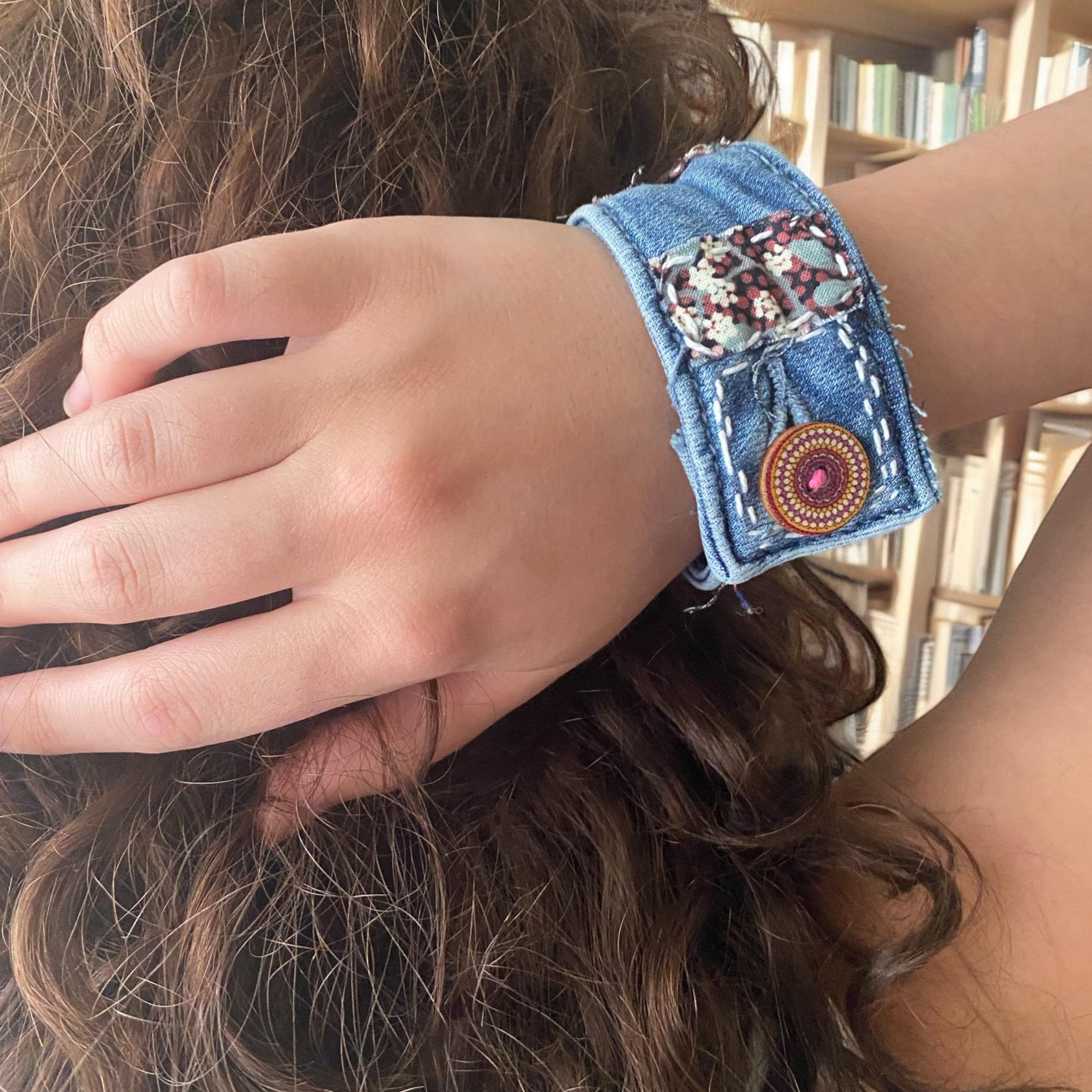 Recycled denim cuff bracelet. Beads and fabric embellishemnts.