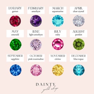 May include: A grid of twelve gemstones representing birthstones for each month. The gemstones are in various colors, including red, purple, blue, green, and pink. Each stone is labeled with the month and gemstone name. The shop name "DAINTY gold shop" is at the bottom.