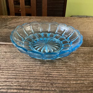 May include: A set of three ceramic nesting bowls in shades of blue, green, and white. The bowls have a speckled glaze and a simple design. The largest bowl is about 18 cm in diameter.