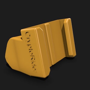 May include: A yellow plastic phone stand with the text "CryptoRider" printed on the side. The stand has two slots for holding a phone.
