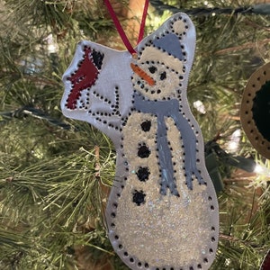 Snowman ornament with Cardinal Bird. Also available in copper or brass metals.