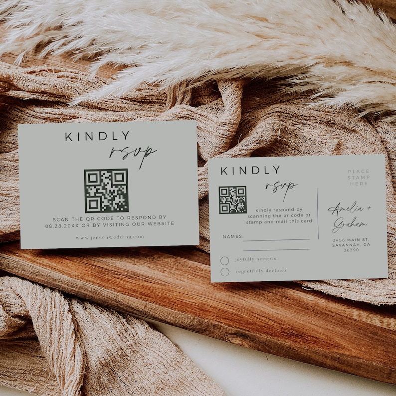May include: Two light green RSVP cards with a QR code and the text "KINDLY RSVP". The card on the left has instructions to scan the QR code or visit the website. The card on the right has a place to write names and a section for guests to indicate if they will joyfully accept or regretfully decline the invitation. The card on the right also has the names Amelia and Grehem, an address, and a place to put a stamp.