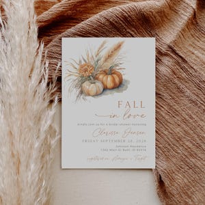 May include: Bridal shower invitation with watercolor pumpkins and fall foliage. The invitation features the text "FALL in love" and details for Clarissa Jensen's bridal shower, including the date, time, and location.