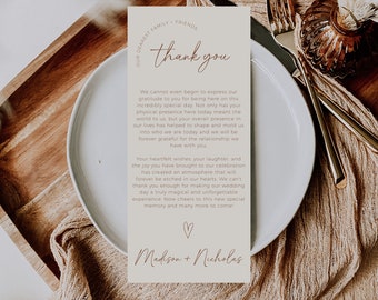 May include: A thank you card with a brown background and white text. The card says "Our Dearest Family & Friends, Thank You" and includes a message of gratitude for the guests' presence at the wedding. The card is signed "Madison + Nicholas".