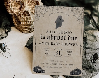 May include: A Halloween-themed baby shower invitation with a ghost illustration and the text "A little boo is almost due Amy's Baby Shower". The date is set for Saturday, October 31st at 7:00 pm. The invitation includes the address and RSVP information.