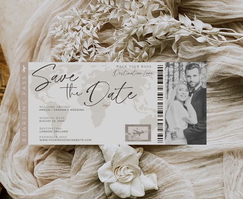 May include: A save the date card with a world map background and a photo of a couple. The text reads "Save the Date" and "Pack Your Bags Destination Love". The card also includes the couple's names, wedding date, and website.