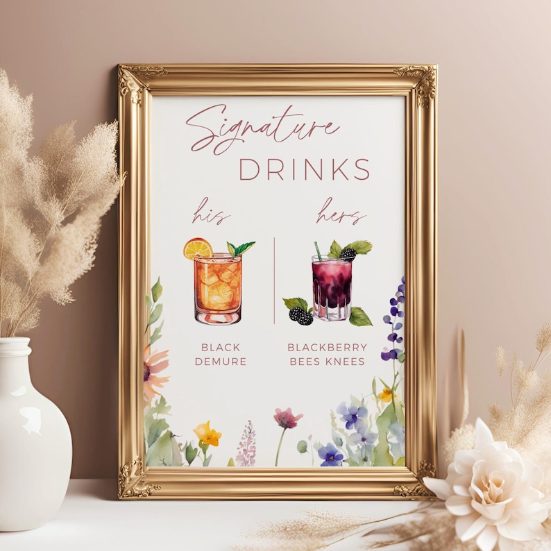 May include: A printable sign with a gold frame and floral accents. The sign says "Signature Drinks" and features two cocktails, one labeled "his" and the other labeled "hers". The cocktail labeled "his" is called "Black Demure" and the cocktail labeled "hers" is called "Blackberry Bees Knees".