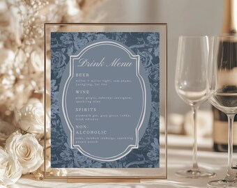 May include: A framed drink menu with a blue floral background. The menu lists beer, wine, spirits, and non-alcoholic beverages. The text "Drink Menu" is at the top. Two wine glasses are visible.