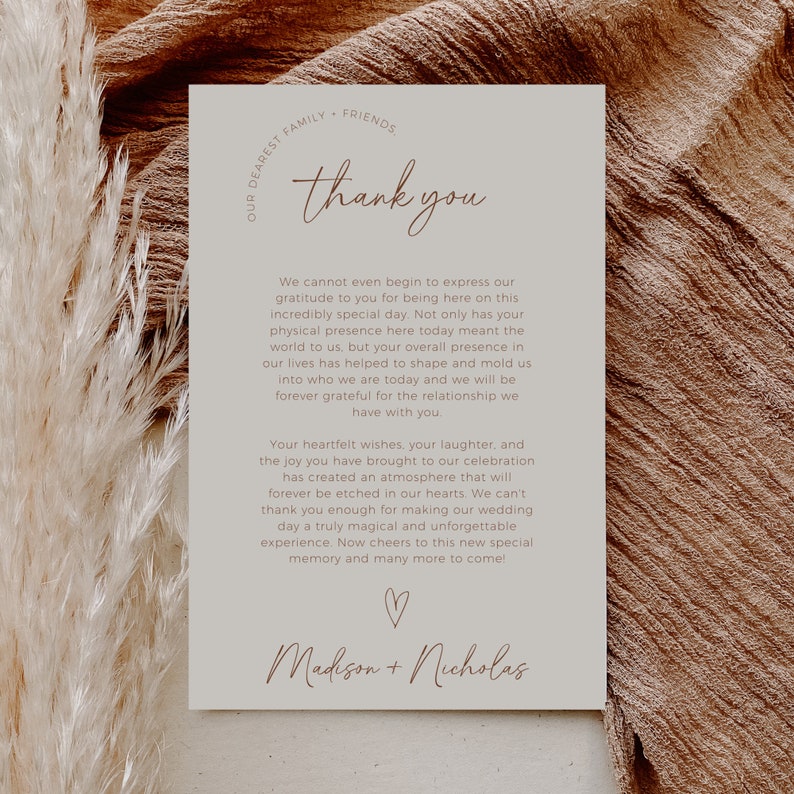 May include: A thank you card with a simple design in beige and brown. The card features the text "thank you" in a handwritten font and the names "Madison + Nicholas" at the bottom. The card expresses gratitude to guests for attending a wedding celebration.