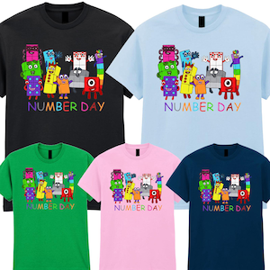 May include: A selection of t-shirts in various colours, including black, light blue, green, pink, and navy. Each shirt displays a cartoon graphic of animated numbers and the text "NUMBER DAY" in rainbow hues.