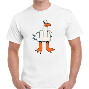 May include: White t-shirt featuring a cartoon image of a bird giving the middle finger.